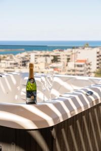a bottle of wine and two glasses sitting on a table at Dea Rethymno in Rethymno