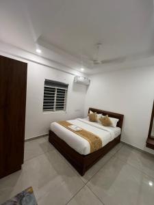 a bedroom with a large bed in a room at Orbis Rooms & Apartments in Kakkanad