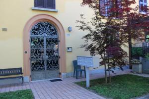a door of a building with a bench next to it at Suite Terrazza Mazzini in Molinella