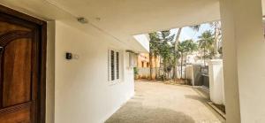 an open door of a white building with a courtyard at The Blessing Villa Vellore in Vellore