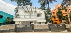 a white house with a gate in front of it at The Blessing Villa Vellore in Vellore