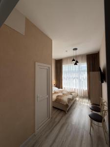 a bedroom with a bed and a large window at Miva in Qusar