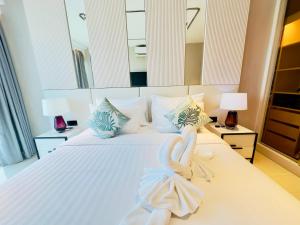 a bedroom with a bed with swans made out of towels at P Residence Phnom Penh in Phnom Penh +144 photos