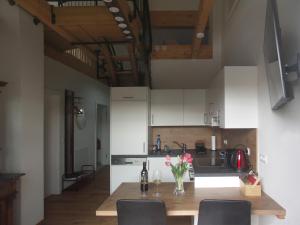 a kitchen with a wooden table with flowers on it at Studio LEOPOLD LEIBNITZ in Leibnitz