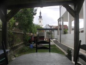a patio with a table and a church in the background at Studio LEOPOLD LEIBNITZ in Leibnitz