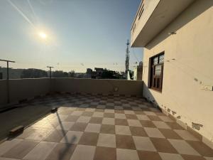 an empty room with a checkered floor on a building at The Loft Homestay Narwana in Narwāna +2 photos