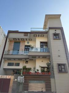 an apartment building with plants on the balconies at The Loft Homestay Narwana in Narwāna