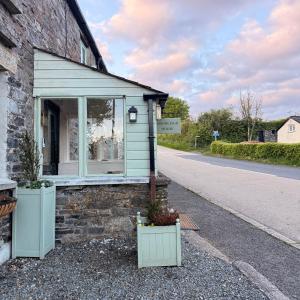 a building with a window on the side of a road at The Old Feed Store in Okehampton