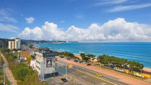 an aerial view of a city and the ocean at Baradeon Bada Pension, Yangyang in Yangyang