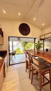a kitchen with a table and chairs in a room at Pipa Sunset Home in Pipa