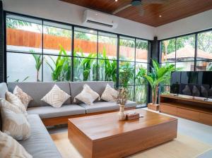 a living room with a couch and a coffee table at Harbie Villa in Seminyak