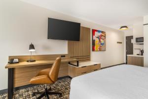 a hotel room with a bed and a desk with a television at Hampton Inn Atlanta-Stockbridge in Stockbridge +45 photos