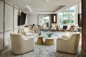 a waiting room with chairs and tables at Hampton Inn & Suites Destin in Destin