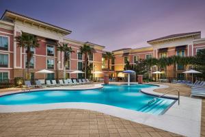 a swimming pool in front of a building at Hampton Inn & Suites Destin in Destin