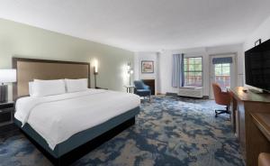 a hotel room with a large bed and a desk at Hampton Inn Helen in Helen