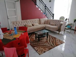 a living room with a couch and a table at Charming Home in Negombo