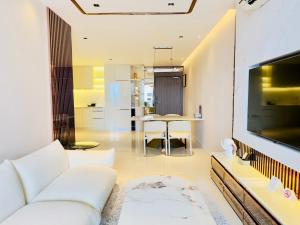 a living room with a white couch and a table at P Residence Phnom Penh in Phnom Penh