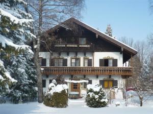 a house in the snow with snow at Gästehaus Heiß in Lenggries