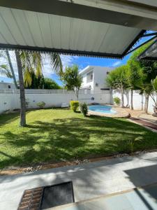 a backyard with a pool and a house at Villa Roche Noire with Pool- 4 mins from Beach in Tamarin
