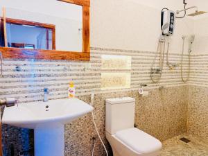 a bathroom with a sink and a toilet and a mirror at Arugam Bay Resort in Arugam Bay +16 photos