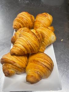 a pile of croissants sitting on a white plate at Riverside Guesthouse in Charlestown