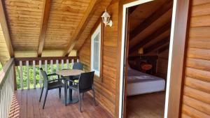 a tiny house with a balcony with a table and chairs at Sol Apartments in Durrës