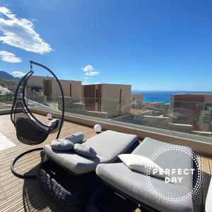 avisor shot of a deck with a hammock on a roof at Perfect Day Luxury Residences in Palasë +13 photos