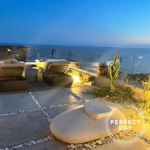 a view of the ocean from a balcony of a house at Perfect Day Luxury Residences in Palasë