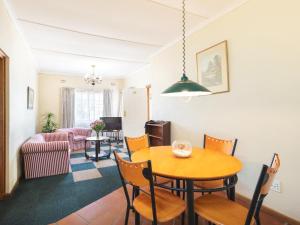 a living room with a table and chairs at Oak lodge Guest House in Grahamstown