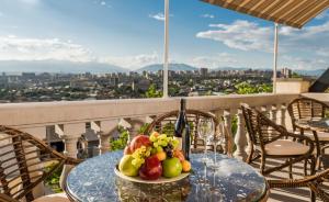a plate of fruit on a table on a balcony at Arève Résidence Boutique Hotel in Yerevan