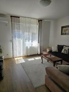 a living room with a couch and a table at Apartman Palma in Belgrade