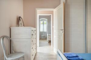 a bedroom with a dresser and a chair and a hallway at Traditional House in Rífion +25 photos