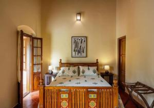 a bedroom with a wooden bed in a room at Villa Mariam in Cheruvalli