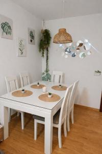 a white table with four chairs and a white table at Casa Nankurunaisa in Vejer de la Frontera