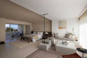 a bedroom with a bed and a living room at WHITEBALANCE Hotel Dali in Dali