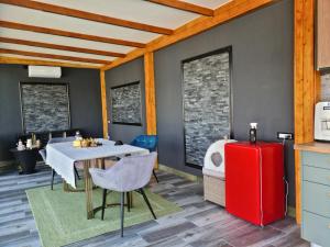 a kitchen with a table and a red refrigerator at Garden of Silance in Cîrcea