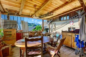 a kitchen and dining room with a table and chairs at Petit chalet Chez Gaston in Saint-François-Longchamp