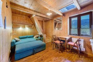 a bedroom with a bed and a table in a room at Petit chalet Chez Gaston in Saint-François-Longchamp