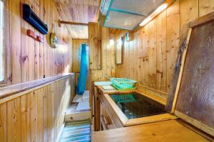 a bathroom with a pond in a wooden room at Petit chalet Chez Gaston in Saint-François-Longchamp +25 photos