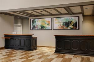 a room with three paintings on the wall and two benches at DoubleTree by Hilton Gainesville in Gainesville +36 photos