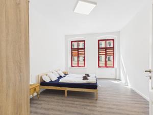 a bedroom with a bed with a cat laying on it at Landeskron38 - LK38 in Görlitz