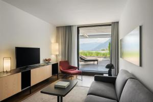 a living room with a couch and a television at Hilton Lake Como in Como