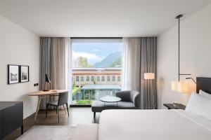 a hotel room with a bed and a desk at Hilton Lake Como in Como +136 photos