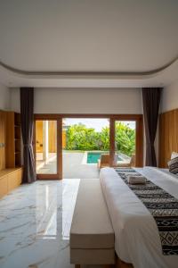 a bedroom with a large bed and a pool at Suralaya Villas in Ubud +127 photos