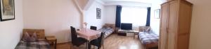 a living room with a table and a couch at Monteurzimmer Ehmen in Wolfsburg