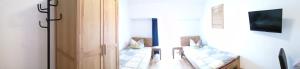 a room with a hallway with a table and a television at Monteurzimmer Ehmen in Wolfsburg