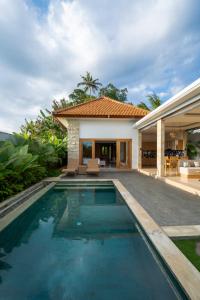 a swimming pool in the backyard of a house at Suralaya Villas in Ubud