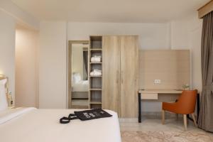 a hotel room with a bed and a desk at Tulip Residences Vipingo Mombasa in Mombasa +53 photos