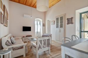 a living room with white furniture and a table at Traditional House in Rífion