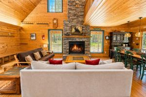a living room with a couch and a fireplace at Pine Acres by NW Comfy Cabins in Leavenworth